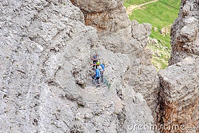 Climbers ascending Sass Pordoi mountain massif, Dolomites Alps, Italy. Editorial Stock Photo