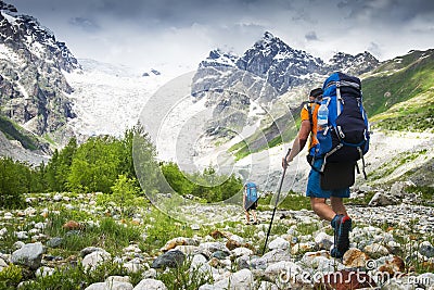 Climbers with hiking backpacks go to the mountain. hikers in mountains. Tourists hike on rocky mounts Stock Photo