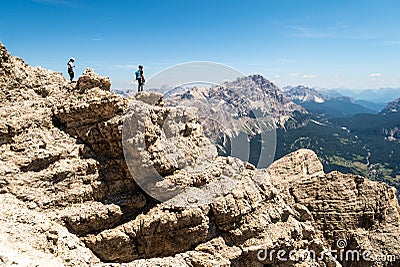 Climbers silhouette standing on a cliff in Dolomites. Tofana di Mezzo, Punta Anna, Italy. Man Celebrate success on top of the moun Editorial Stock Photo