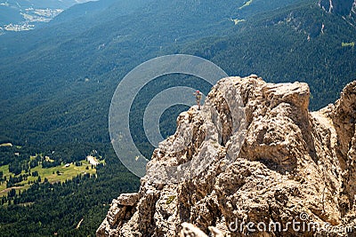 Climbers silhouette standing on a cliff in Dolomites. Tofana di Mezzo, Punta Anna, Italy. Man Celebrate success on top of the moun Editorial Stock Photo