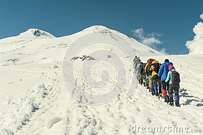 Climbing Elbrus group of climbers goes in the snow to the top. Stock Photo