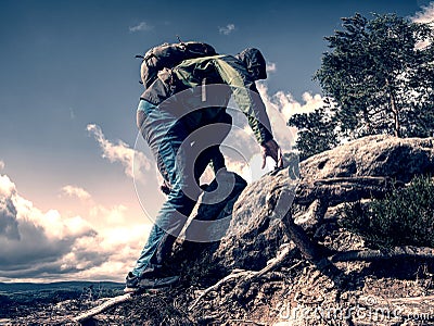 Climbing high up. Mountaineer with backpack hiking Stock Photo