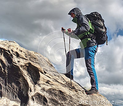 Climbing high up. Mountaineer with backpack hiking Stock Photo