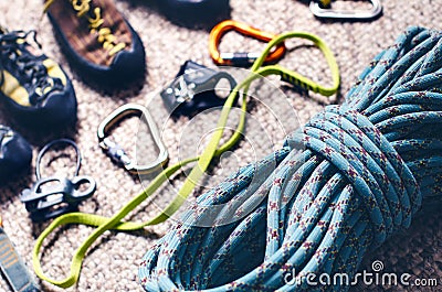 Climbing and mountaineering equipment on a carpet. Shoes, carbine, rope, lope, ascend-er. Concept of outdoor and extreme sport. Stock Photo