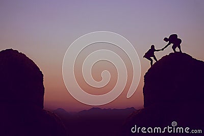Climbing people in mountains as symbol for team spirit Stock Photo