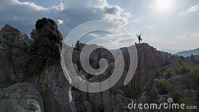 The climbing success of the mountaineer on the jagged cliffs, adventure and therapy in the magnificent mountains Stock Photo