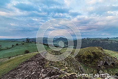 Climbing up in the mount on the morning in the Peak District, Thor Cave. Stock Photo