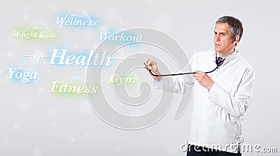 Clinical doctor pointing to health and fitness collection of words Stock Photo