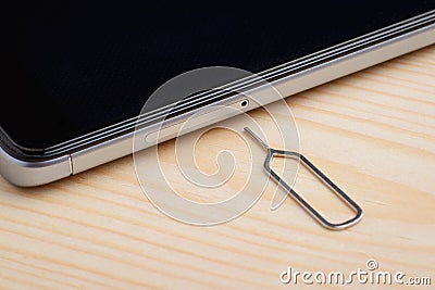 Clip for removing SIM card tray Stock Photo