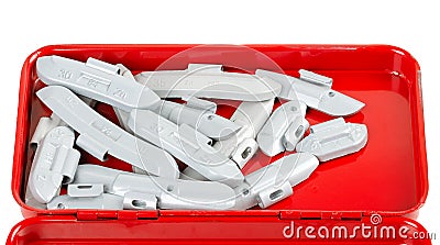 Clip-on zinc tire weights in red metal box Stock Photo