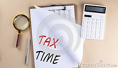 Clipboard with chart and text TAX TIME with magnifier ,calculator on beige background Stock Photo