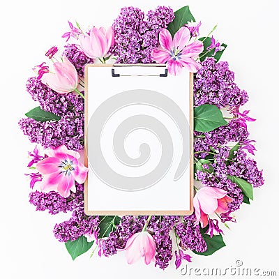 Clipboard, tulips and lilac branch on pink background. Flat lay, top view. Beauty blog concept. Stock Photo