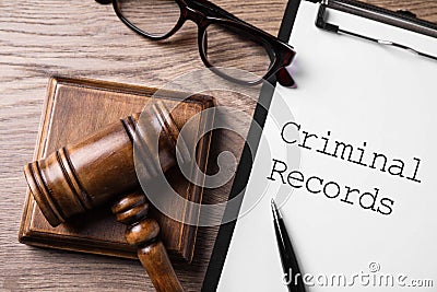 Clipboard with words CRIMINAL RECORD and gavel on table, flat lay Stock Photo