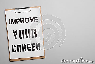 Clipboard with words IMPROVE YOUR CAREER on background, top view. Space for text Stock Photo