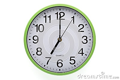 Clipping path included. Clock on white background showing seven o`clock Stock Photo