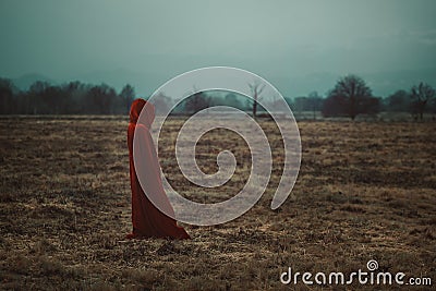 Cloaked person in a cold moorland Stock Photo