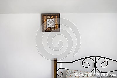 Clock hanging on a white wall in countryhouse Stock Photo