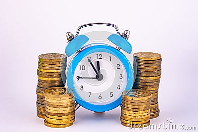 Clock and stacks of coins close-up Stock Photo