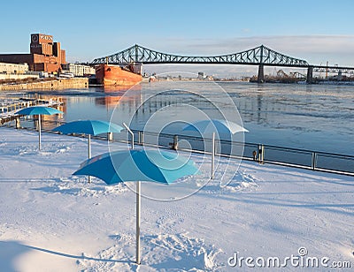 A Snowy Clock Tower Beach in Montreal with the Molson Brewery in Editorial Stock Photo