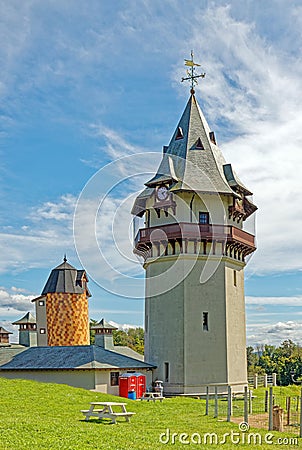 clock tower with clocks on each face side and weathervane on top Stock Photo