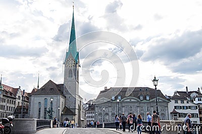 Clock tower of Kirche Fraumunster shot from Munsterbrucke at evening time. Editorial Stock Photo