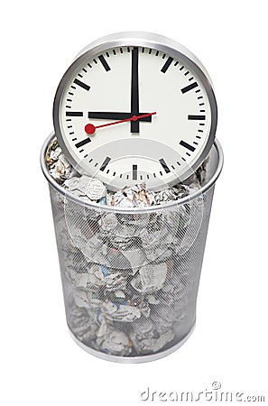 Clock in wastebasket full of crumpled paper over white background Stock Photo