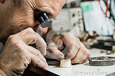 Clockmaker repairing wrist watch Stock Photo