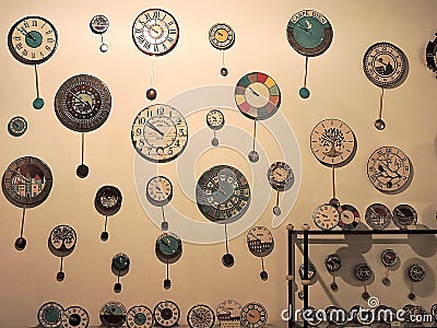Clocks of different shapes and sizes on the wall of the waWatches of different shapes and sizes on the wall of the watch shop Editorial Stock Photo