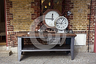 Clocks on an industrial table in the Paris Flea Market Editorial Stock Photo