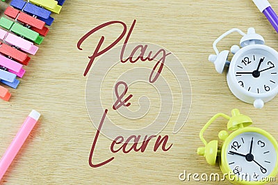 Clocks, pen colors and clothespins with text PLAY and LEARN Stock Photo
