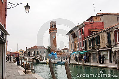 Clocktower, colorful houses and canal on the island of Murano near Venice Editorial Stock Photo