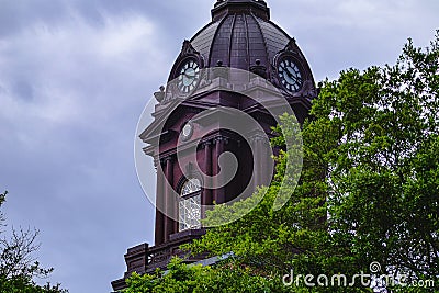 Clocktower of Newnan, Georgia courthouse behind trees with blue sky Stock Photo