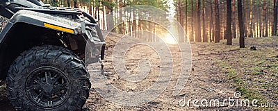 Clode-up side of ATV awd quadbike motorcycle profile view dirt country forest road beautiful nature morning sunrise Stock Photo