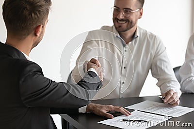 Cloe up of businessmen shake hands closing deal at negotiations Stock Photo