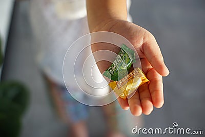 Cloes up Halls candy on liitle girl hand. Editorial Stock Photo