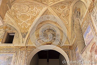 Cloister Santa Chiara, view of corridor under arcades and decorated colorful frescoes, Naples, Italy Editorial Stock Photo