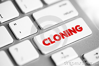 Cloning is the process of producing individual organisms with identical genomes, text concept button on keyboard Stock Photo