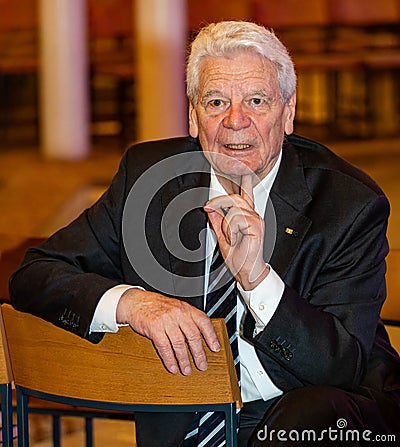 Former Federal President Joachim Gauck sits sideways on a chair while talking Editorial Stock Photo
