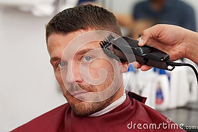 Male client getting haircut by hairdresser. Stock Photo