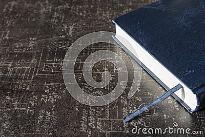 Close blue book with book marker on gray stone table. Education and learning concept. Science background. Stock Photo