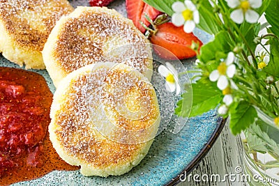 Close cheese pancakes, syrniki, curd fritters with fresh strawberries on plate background Stock Photo