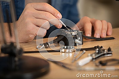 close cropped view wrist watch being repaired Stock Photo