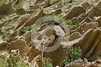 At close of the famous Stob Pyramids with unusual shape red and yellow rock formations, green bushes and trees around Stock Photo