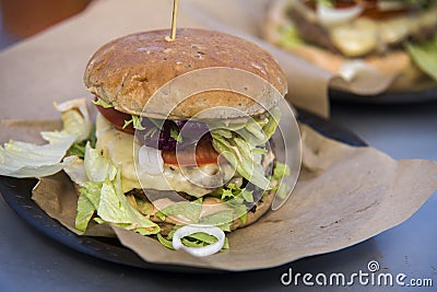 Close on fast food unhealthy burger on paper, Stock Photo