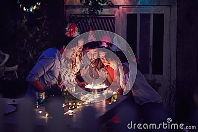 Close friends blowing birthday candles together. togetherness, making a wish, close, friends, concept Stock Photo