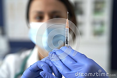 Close front view of doctor with syringe ready for use Stock Photo