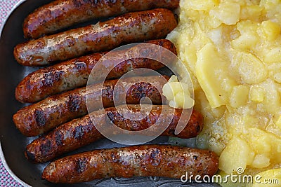 Close grilled Nuremberg sausages with potato Stock Photo