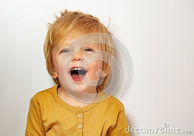 Close happy blond little boy portrait laughing Stock Photo