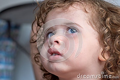 Close of Little Brazilian girl looking up Stock Photo