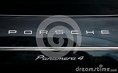Close Logo Logotype Sign Of Porsche On Black Background. Black porsche panamera 4 Editorial Stock Photo